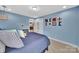 Comfortable bedroom with blue walls, and a bed with decorative pillows at 2015 Knocktree Dr, Indian Trail, NC 28079