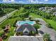 Aerial view of a community pool with lounge chairs, parking, and surrounding green space at 2015 Knocktree Dr, Indian Trail, NC 28079