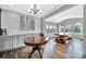 Open dining area features built in cabinets, a wine cooler, and a rustic dining table with window views at 2015 Knocktree Dr, Indian Trail, NC 28079