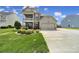 Charming two-story home with a well-manicured front yard and a two-car garage at 2015 Knocktree Dr, Indian Trail, NC 28079