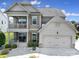 Beautiful two-story home with a covered porch, balcony, attached garage, and manicured landscaping at 2015 Knocktree Dr, Indian Trail, NC 28079