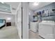 Efficient laundry room equipped with a washer, dryer, and shelving for storage at 2015 Knocktree Dr, Indian Trail, NC 28079