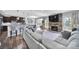 Open-concept living room and kitchen area, featuring a stone fireplace and hardwood floors at 2015 Knocktree Dr, Indian Trail, NC 28079