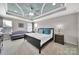 Spacious main bedroom with a tray ceiling, sitting area, and neutral decor at 2015 Knocktree Dr, Indian Trail, NC 28079