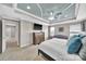 This is a stylish main bedroom with a decorative tray ceiling, ceiling fan, and a seating area in the corner at 2015 Knocktree Dr, Indian Trail, NC 28079