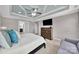 Main bedroom with a tray ceiling, ceiling fan, dresser and an ensuite bathroom at 2015 Knocktree Dr, Indian Trail, NC 28079