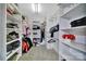 Well-organized walk-in closet with shelving and rods for ample storage, maximizing space and convenience at 2015 Knocktree Dr, Indian Trail, NC 28079