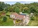 Aerial view of home with a private backyard, in-ground pool, and mature trees at 206 Cedarwood Dr, Salisbury, NC 28147