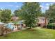 View of backyard with pool, patio seating, and lush green lawn at 206 Cedarwood Dr, Salisbury, NC 28147