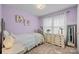 Charming bedroom with soft purple walls, floral decor, and inviting natural light creating a tranquil space at 206 Cedarwood Dr, Salisbury, NC 28147