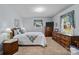 Bright bedroom showcasing wooden furniture and soft natural light creating a peaceful and serene environment at 206 Cedarwood Dr, Salisbury, NC 28147