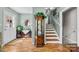 Inviting foyer with hardwood floors, elegant display cabinet, and staircase to upper level at 206 Cedarwood Dr, Salisbury, NC 28147