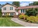 Beautifully landscaped front yard with walkway leading to a charming brick and siding home at 206 Cedarwood Dr, Salisbury, NC 28147