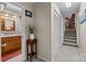 Hallway view of downstairs bathroom with cabinet and stairway to the kitchen at 206 Cedarwood Dr, Salisbury, NC 28147
