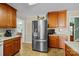 Bright kitchen with stainless steel refrigerator and stylish cabinets, connecting to the adjacent dining area at 206 Cedarwood Dr, Salisbury, NC 28147
