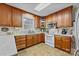 Well-lit kitchen featuring wooden cabinets, modern appliances, and tile flooring for a clean, stylish space at 206 Cedarwood Dr, Salisbury, NC 28147