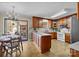 Well-equipped kitchen with an island, wood cabinets, and sliding door access to patio at 206 Cedarwood Dr, Salisbury, NC 28147