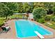 Refreshing in-ground pool with diving board, ladder, and an ample sunbathing area for enjoyment at 206 Cedarwood Dr, Salisbury, NC 28147