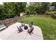 Large backyard with a fire pit, lounge chairs and lush greenery at 2124 Chatham Ave, Charlotte, NC 28205