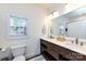 Bathroom features a double vanity with marble countertops and modern fixtures at 2124 Chatham Ave, Charlotte, NC 28205