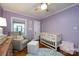 Cozy Bedroom with a rocking chair, crib, and hardwood floors at 2124 Chatham Ave, Charlotte, NC 28205