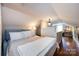 Bedroom showcasing cozy decor, hardwood floors, natural light, and comfortable furnishings at 2124 Chatham Ave, Charlotte, NC 28205