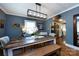 Rustic dining room features a wooden table, bench, and modern light fixture near the kitchen at 2124 Chatham Ave, Charlotte, NC 28205