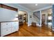 Bright entryway featuring hardwood floors, a coat rack, archway to dining room, and stairs to upper level at 2124 Chatham Ave, Charlotte, NC 28205