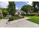 Inviting one-story home with lush landscaping, a well-maintained lawn, and a driveway leading to a garage at 2124 Chatham Ave, Charlotte, NC 28205