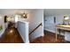 Upper hallway with hardwood floors leading to living spaces and featuring a workspace area at 2124 Chatham Ave, Charlotte, NC 28205