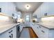 Bright white kitchen featuring granite countertops, white cabinets, subway tile, and stainless steel appliances at 2124 Chatham Ave, Charlotte, NC 28205