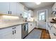 Updated kitchen featuring white cabinets, granite countertops, subway tile backsplash, and stainless appliances at 2124 Chatham Ave, Charlotte, NC 28205