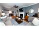 Inviting living room featuring hardwood floors, a fireplace, a ceiling fan, and comfortable seating at 2124 Chatham Ave, Charlotte, NC 28205