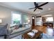 Bright living room featuring hardwood floors, an archway to the entry, and comfortable sofas and decor at 2124 Chatham Ave, Charlotte, NC 28205