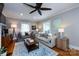 Bright living room with hardwood floors, two sofas, large windows, and a ceiling fan at 2124 Chatham Ave, Charlotte, NC 28205