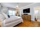 Spacious main bedroom with hardwood floors, ceiling fan, and ensuite bathroom at 2124 Chatham Ave, Charlotte, NC 28205
