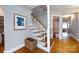 Traditional staircase with hardwood floors, white railings, and an inviting entryway at 2124 Chatham Ave, Charlotte, NC 28205