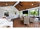Cozy screened porch with wicker furniture, wood floors, ceiling fan, and TV at 2124 Chatham Ave, Charlotte, NC 28205