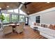 Inviting sunroom features vaulted ceilings, wood floors and ample seating with a backyard view at 2124 Chatham Ave, Charlotte, NC 28205