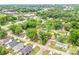 An aerial view highlights the lush green surroundings in a quiet neighborhood at 225 N Lee St, Mount Holly, NC 28120