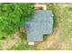 Aerial view of house featuring green shingled roof, small deck, and lush lawn at 225 N Lee St, Mount Holly, NC 28120
