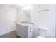 Well-lit bathroom with grey vanity, granite countertop, white fixtures, and a mirror at 225 N Lee St, Mount Holly, NC 28120