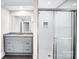 Stylish bathroom featuring granite countertops, a modern vanity, and a sleek tiled shower with glass doors at 225 N Lee St, Mount Holly, NC 28120
