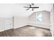 Bedroom with angled ceiling, door to the left, hardwood floors, a window, and a black ceiling fan at 225 N Lee St, Mount Holly, NC 28120