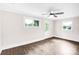 Bright bedroom features wood-look flooring, white trim, ample natural light, and a modern ceiling fan at 225 N Lee St, Mount Holly, NC 28120