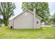 Side view of single-story home with neutral siding, chimney, and well-kept lawn at 225 N Lee St, Mount Holly, NC 28120
