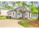 This home offers a long driveway with an updated exterior paint at 225 N Lee St, Mount Holly, NC 28120