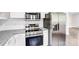 Modern kitchen showcasing stainless steel appliances, granite countertops, white cabinets, and a stylish microwave at 225 N Lee St, Mount Holly, NC 28120