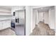 Kitchen featuring stainless steel appliances, white cabinets, granite countertops, and access to the hallway at 225 N Lee St, Mount Holly, NC 28120