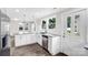 Kitchen boasts white cabinets, granite countertops, stainless steel appliances, and modern pendant lighting at 225 N Lee St, Mount Holly, NC 28120